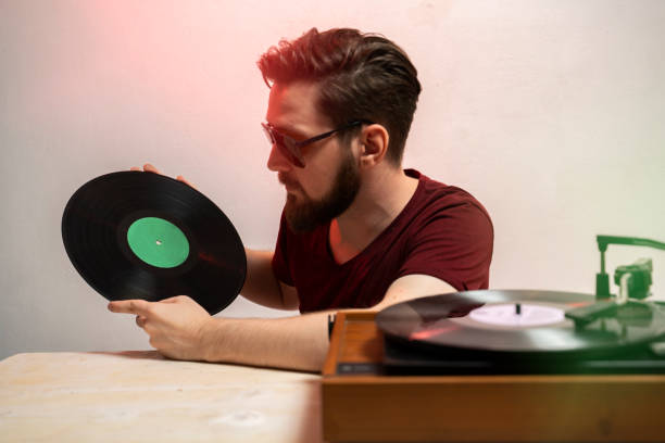 istock Hipster man holding music record 1179637849