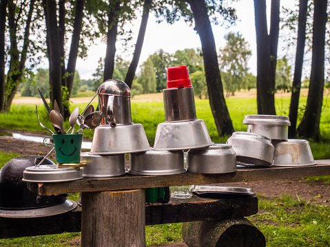 Cooking a meal on a campfire in metal vessels during a  canoeing excursion on the Wieprza river. Poland. Europe. Eastern Europe