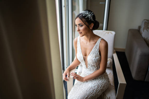 Beautiful young bride posing in hotel apartment on wedding day