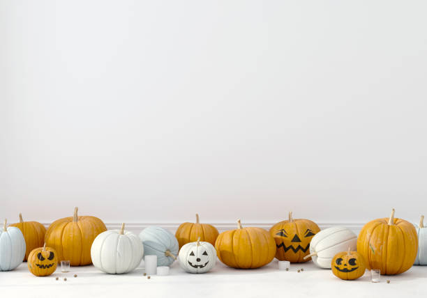 istock Pumpkins with funny faces on a white wall background 1179641910
