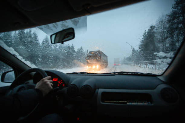 남자는 비와 눈이 날때 황혼에 눈 폭풍에 겨울 스피드 웨이에 차를 운전. 겨울에 나쁜 가시성과 위험한 조건에서 운전의 개념. - dashboard truck driving colors 뉴스 사진 이미지