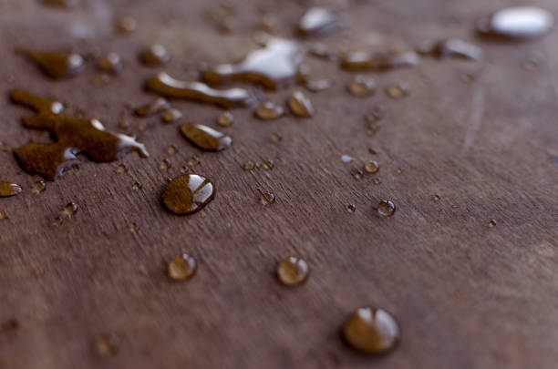 istock Transparent water drops are clearly visible on a mate wooden table. 1179642249