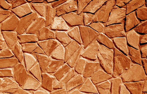 parete fatta di vecchie pietre in tono arancione - 16615 foto e immagini stock