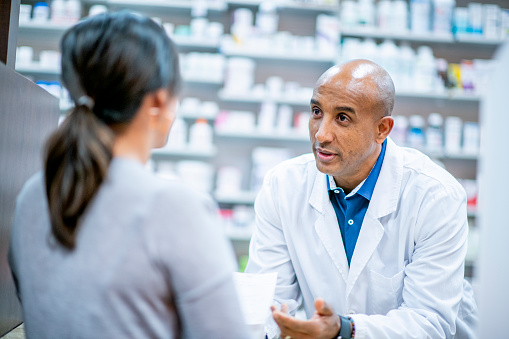 Medical professionals and pharmacists provide medication at the pharmacy.