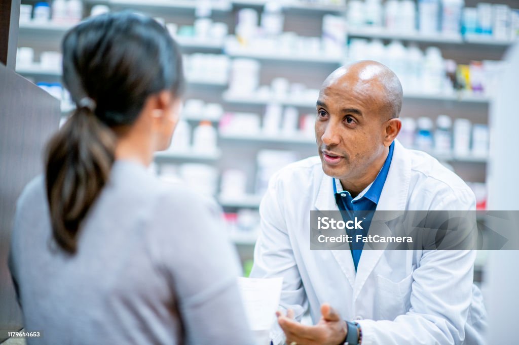 Pharmacy stock photo Medical professionals and pharmacists provide medication at the pharmacy. Pharmacist Stock Photo