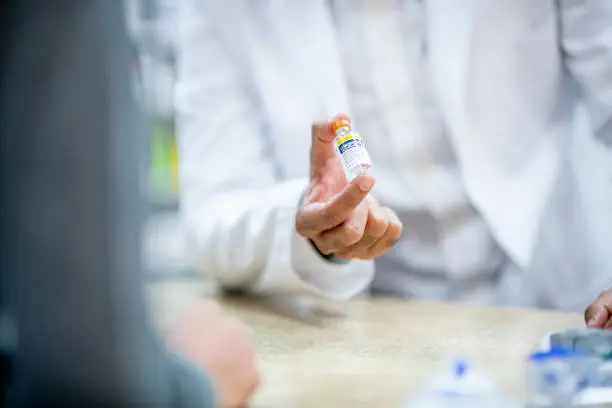 Medical professionals and pharmacists provide medication at the pharmacy.