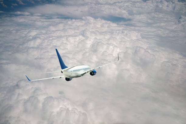 istock Passenger jet airplane flying above clouds 1179647358