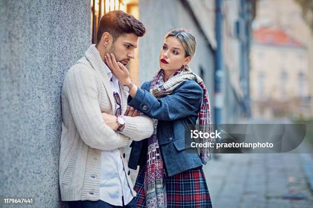Woman Is Consoling Her Sulking Boyfriend On The Street Stock Photo - Download Image Now