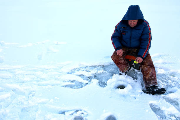 istock Fisherman Winter on the Lake 1179648947