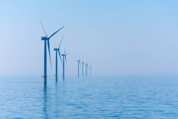 Offshore Wind Farm Wind turbines in the North Sea of the coast of England. offshore wind farm stock pictures, royalty-free photos & images
