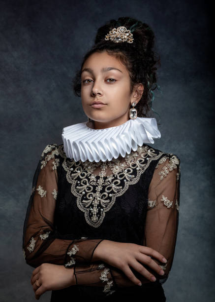 Portrait of a teen girl with dark curly hair, wearing a ruffled collar and  dress in vintage style. Portrait of a teen girl with dark curly hair, wearing a ruffled collar and  dress in vintage style. neck ruff stock pictures, royalty-free photos & images