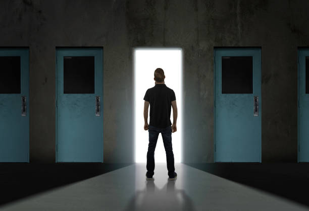 istock Man standing in front of large door 1179651486