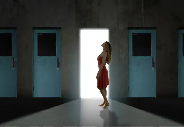 Woman looking up in red dress in front of door