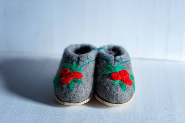 istock felted embroidered wool Slippers on the sole, shot on a white background 1179652613