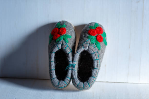 istock felted embroidered wool Slippers on the sole, shot on a white background 1179652656