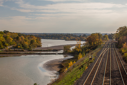 Autumn Scene overlooking train tracks beside waterway