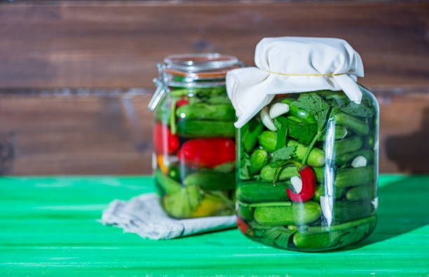 istock Preserves or pickled vegetables in glass jars. 1179656520