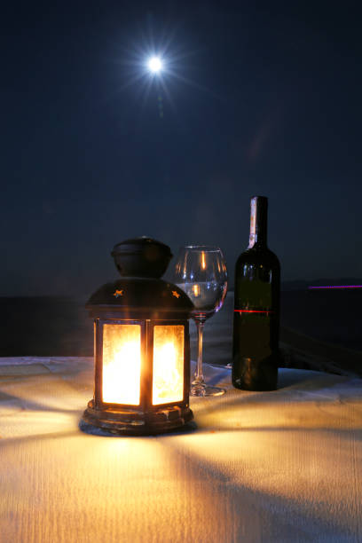 istock red wine glasses lamp Romance in the moonlight 1179658752