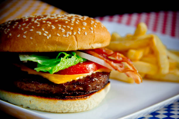 A bacon cheeseburger ready to eat.