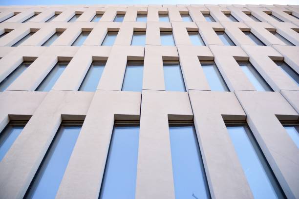 istock Modern office building detail. Perspective view of geometric angular concrete windows on the facade of a modernist brutalist style building. 1179662406