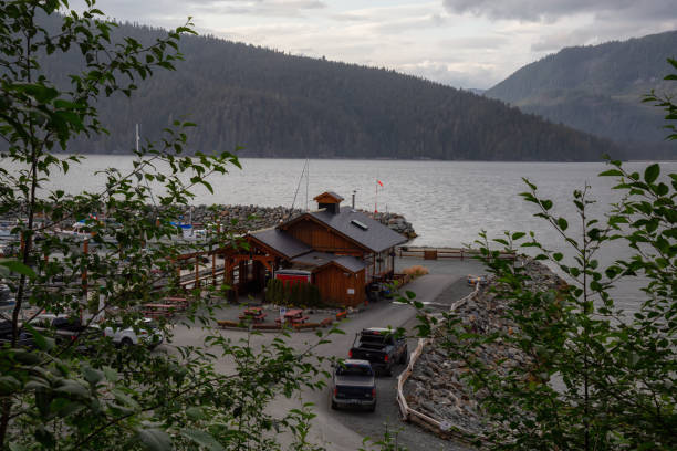 Port Renfrew Port Renfrew, Vancouver Island, British Columbia, Canada - July 18, 2019: Restaurant near Marina on the Ocean Coast during a cloudy summer day. port renfrew stock pictures, royalty-free photos & images