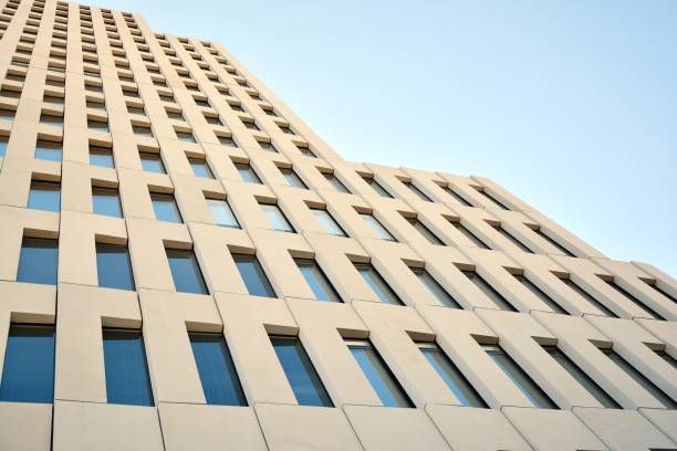 istock Modern office building detail. Perspective view of geometric angular concrete windows on the facade of a modernist brutalist style building. 1179662600