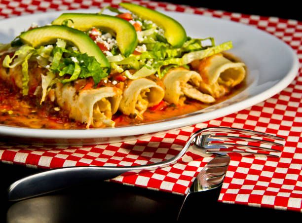 istock Red Enchilada with avocado slices and crumbled cheese 1179663907