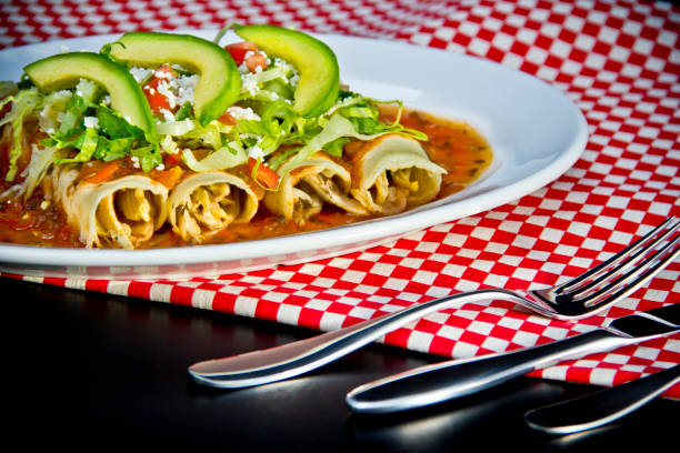 istock Red Enchilada with avocado slices and crumbled cheese 1179663964