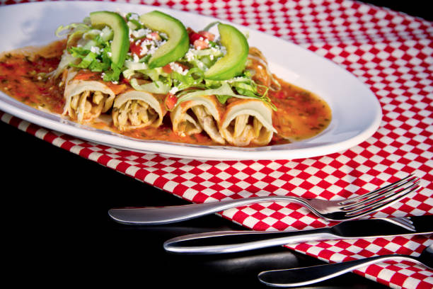 istock Red Enchilada with avocado slices and crumbled cheese 1179664046