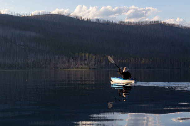 istock Man Kayaking in Lake McDonald 1179665727