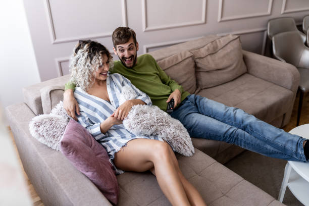 istock Young couple on Sofa Watching TV 1179665846