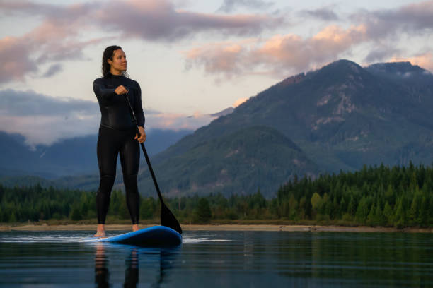 istock Girl Paddle Boarding in a Lake 1179665883