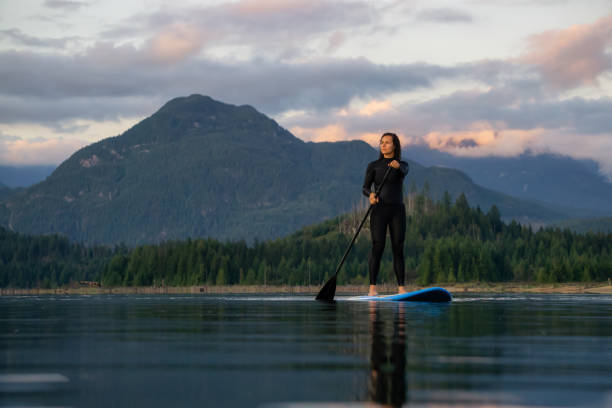 istock Girl Paddle Boarding in a Lake 1179665925