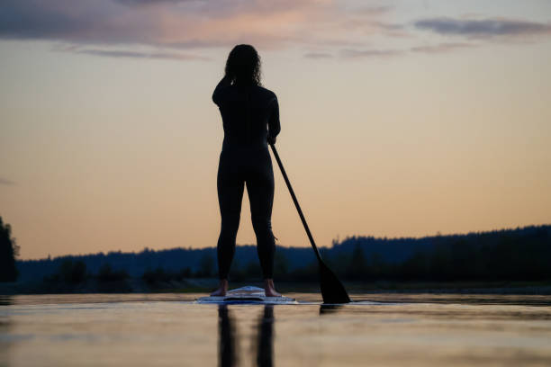 istock Girl Paddle Boarding in a Lake 1179666453