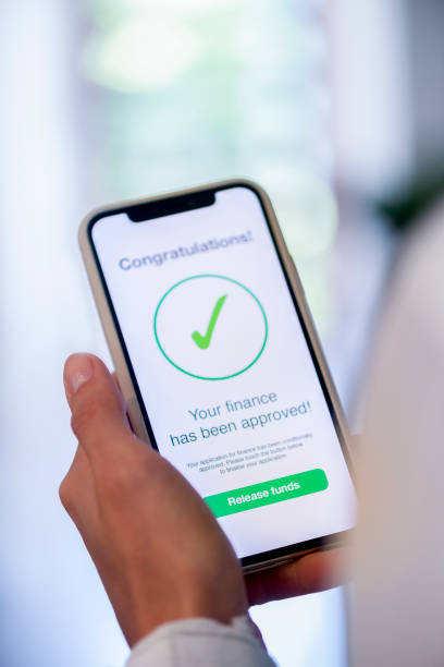 istock Woman holding a mobile phone with loan application approval. 1179667630