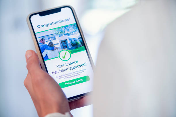 istock Woman holding a mobile phone with loan application approval. 1179667632
