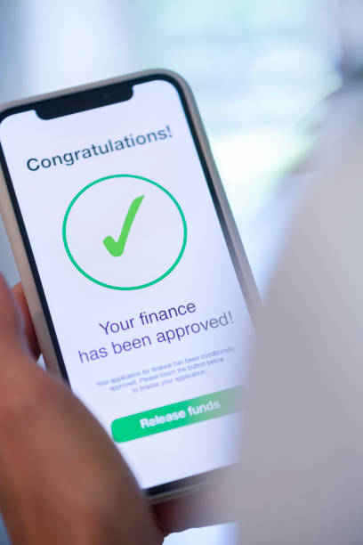 istock Woman holding a mobile phone with loan application approval. 1179667634