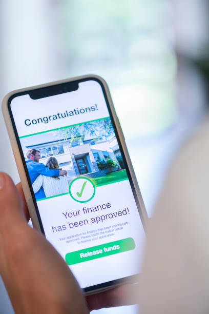 istock Woman holding a mobile phone with loan application approval. 1179667637