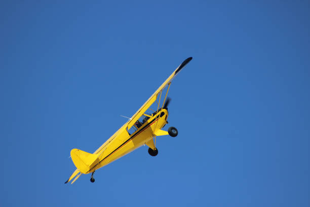 istock airplane with propeller flying in blue sky 1179668060