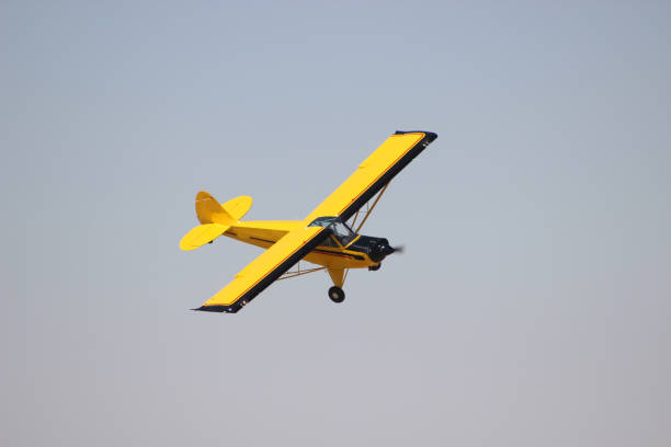 istock airplane with propeller flying in blue sky 1179668062