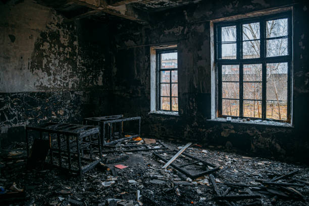 Burned interiors after fire in industrial or office building. War or fire consequences concept Burned interiors after fire in industrial or office building. War or fire consequences concept. burning house stock pictures, royalty-free photos & images