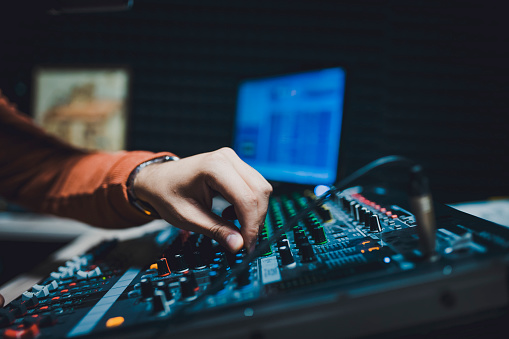 Hand with sound recording studio mixer