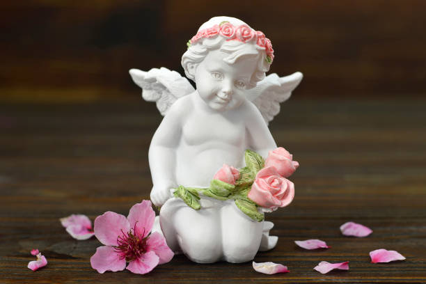 istock Cherub angel and spring flowers 1179670111