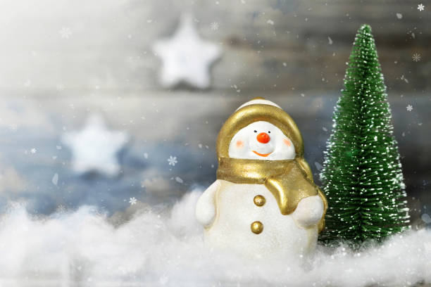 istock Snowman and Christmas tree in winter scene 1179672473