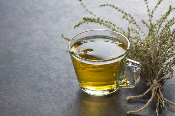 istock glass cup of healthy herbal thyme tea with fresh thyme leaves bunch on grey rustic background, hot drink thymus vulgaris 1179672818