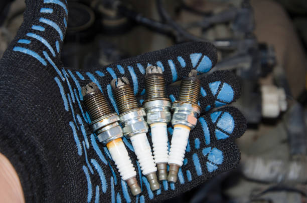 istock Car repair. Replacing spark plugs. Old spent candles covered with soot. 1179672905