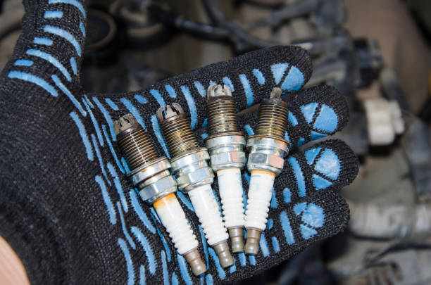 istock Car repair. Replacing spark plugs. Old spent candles covered with soot. 1179672925