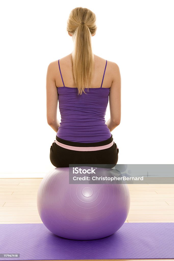 Female working out with an excercise ball  20-24 Years Stock Photo