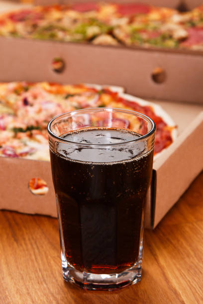 istock Glass of coke and pizza 1179675417