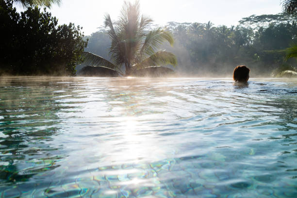 istock A young woman relaxing in a luxurious infinity pool 1179678043
